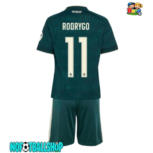 Real Madrid Rodrygo Goes #11 Bortedraktsett Barn 2026-27 Kortermet (+ Korte bukser) Real Madrid Rodrygo Goes #11 Bortedraktsett Barn 2026-27 Kortermet (+ Korte bukser)